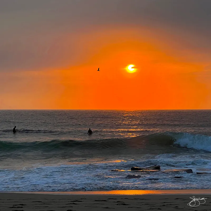 Surfers in the Morning's Glow