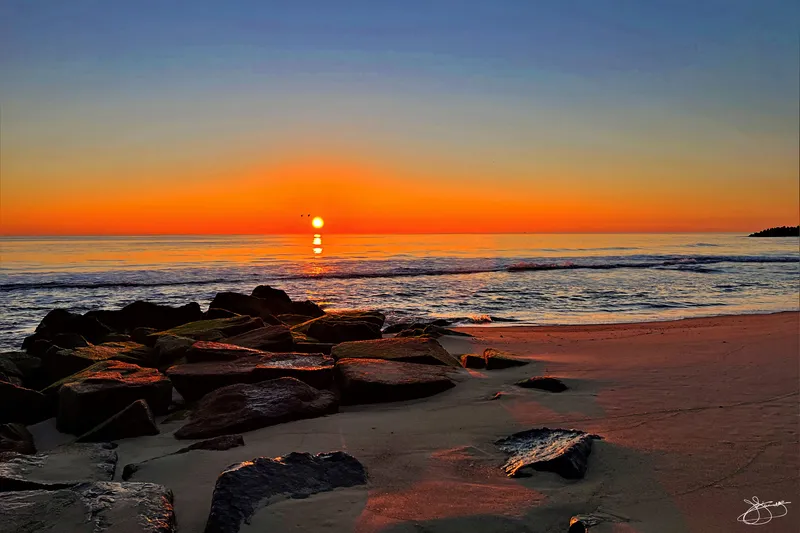 Calm Ocean and Cloudless Beach Sunrise
